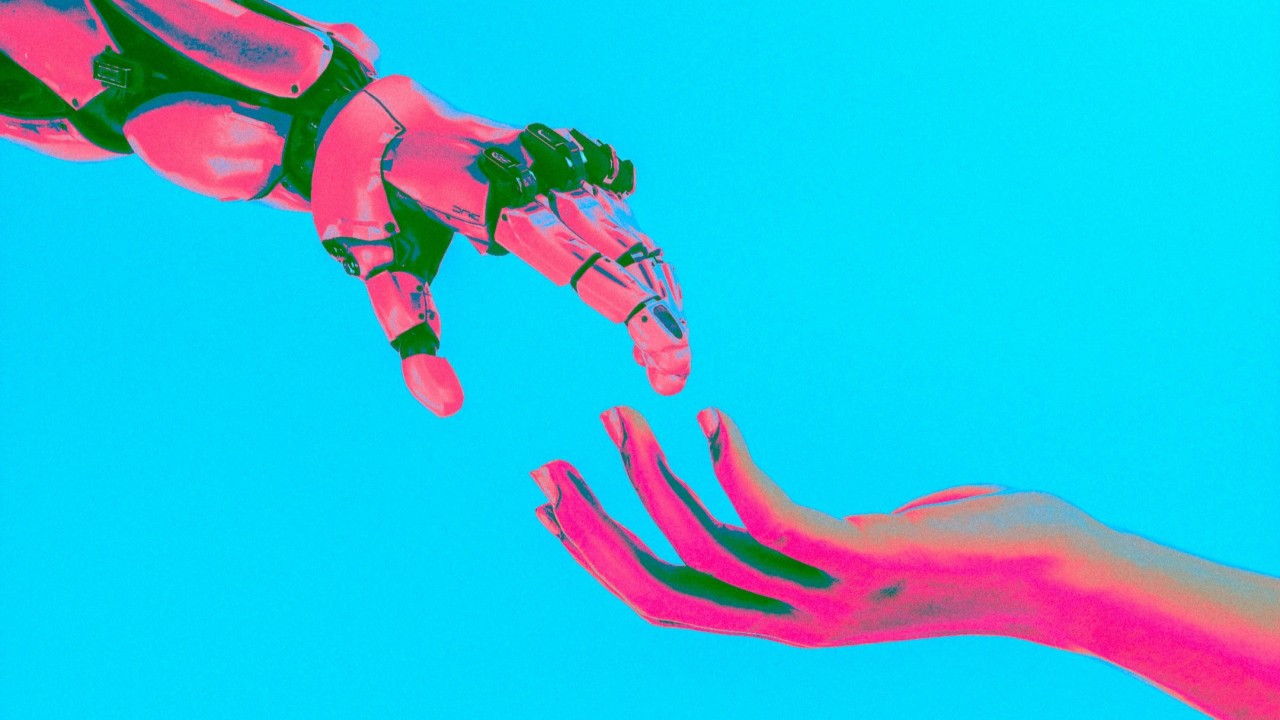 A hand reaching out to a robot hand